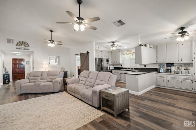 404 Mckinley St, Taft, CA 93268 - living room featuring a barn door, dark wood-style floors, ceiling fan, and lofted ceiling