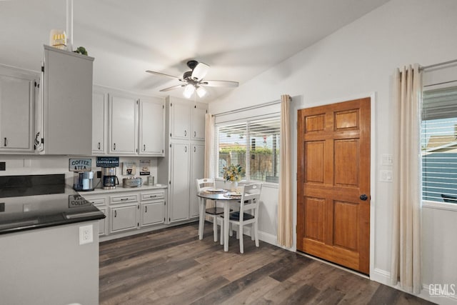 404 Mckinley St, Taft, CA 93268 - kitchen featuring ceiling fan, dark wood-style floors, lofted ceiling, and white cabinets