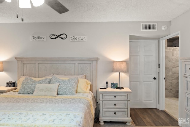 404 Mckinley St, Taft, CA 93268 - bedroom featuring dark wood finished floors, a textured ceiling, and ceiling fan