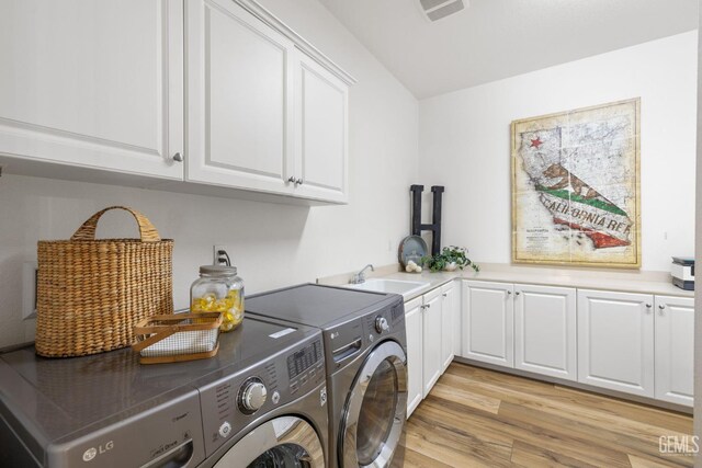9700 Kingsport Pl, Bakersfield, CA 93306 - laundry area featuring cabinet space, washer and clothes dryer, and light wood-style flooring