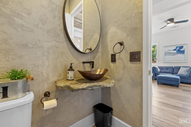 9700 Kingsport Pl, Bakersfield, CA 93306 - half bath featuring a sink, toilet, wood finished floors, and ceiling fan