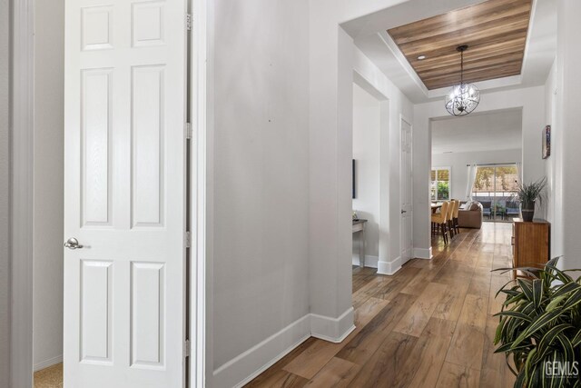 9700 Kingsport Pl, Bakersfield, CA 93306 - hallway featuring a raised ceiling, baseboards, and hardwood / wood-style floors