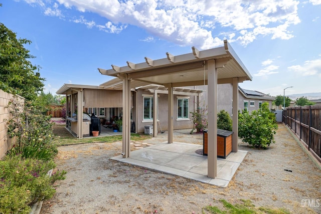 9700 Kingsport Pl, Bakersfield, CA 93306 - rear view of property featuring stucco siding, a fenced backyard, and a patio area