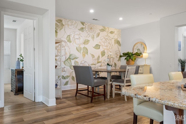 9700 Kingsport Pl, Bakersfield, CA 93306 - dining area featuring an accent wall, light wood-style floors, baseboards, recessed lighting, and wallpapered walls