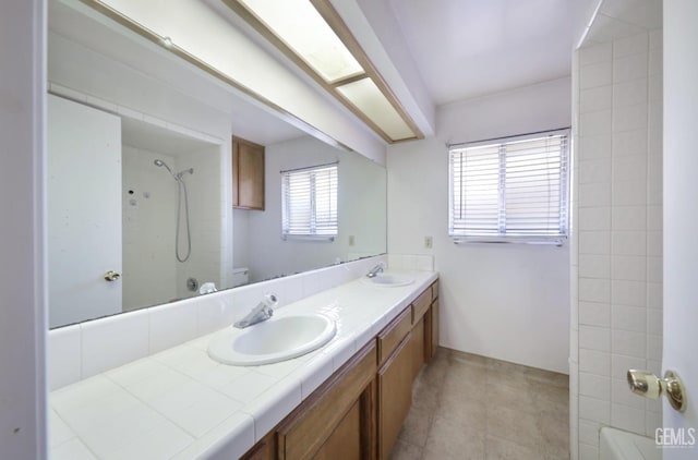 full bath featuring bathing tub / shower combination, double vanity, toilet, and tile patterned floors