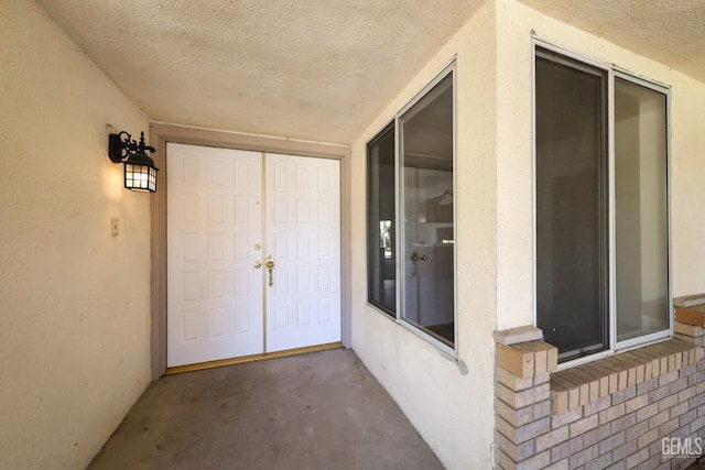 doorway to property featuring stucco siding
