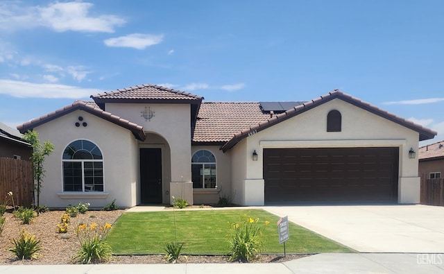4607 Dry Port Way, Bakersfield, CA 93306 - mediterranean / spanish-style house with stucco siding, a garage, roof mounted solar panels, a tiled roof, and driveway