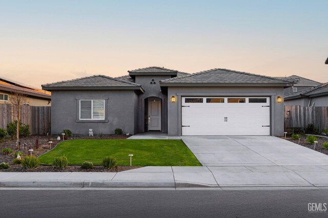 8615 Littleton St, Bakersfield, CA 93314 - prairie-style house with a garage and a yard