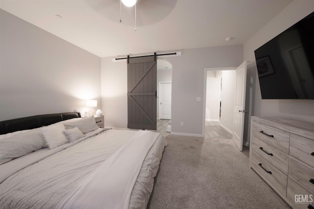 8615 Littleton St, Bakersfield, CA 93314 - bedroom with a barn door, light colored carpet, and ceiling fan