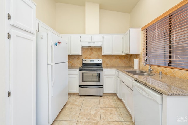 kitchen with light stone countertops, white appliances, sink, light tile patterned floors, and white cabinets