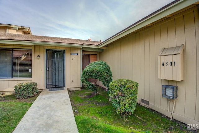 doorway to property featuring a yard