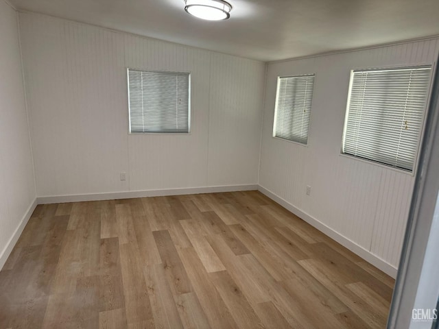 empty room with light hardwood / wood-style flooring