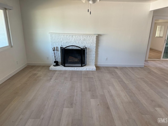 unfurnished living room with light hardwood / wood-style floors and a fireplace