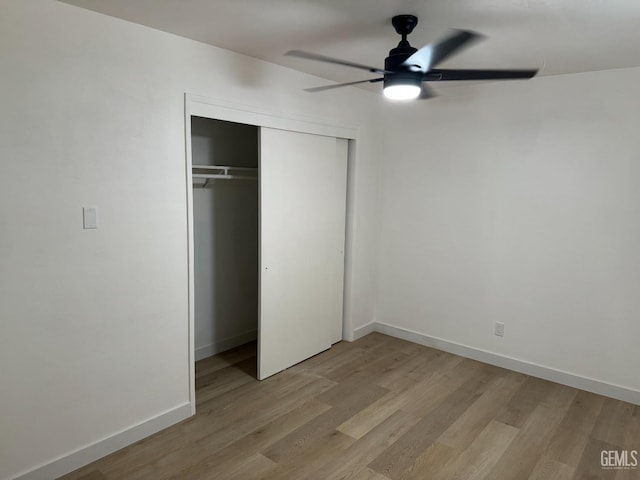 unfurnished bedroom with ceiling fan, light hardwood / wood-style floors, and a closet