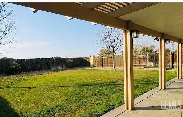 5429 White Wheat Ave, Bakersfield, CA 93313 - fenced backyard with a patio area