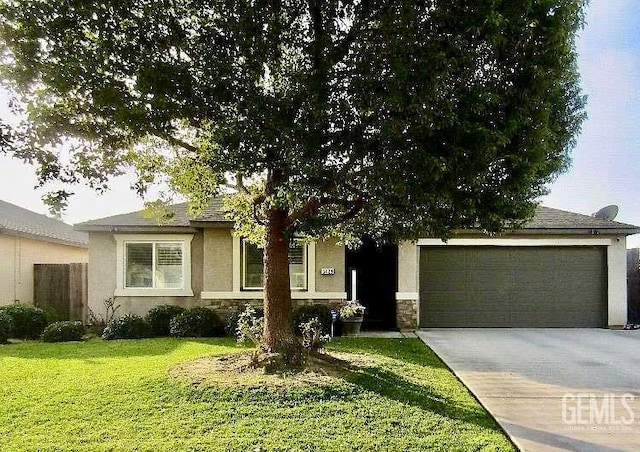 5429 White Wheat Ave, Bakersfield, CA 93313 - view of property hidden behind natural elements with driveway, an attached garage, stone siding, a front lawn, and stucco siding