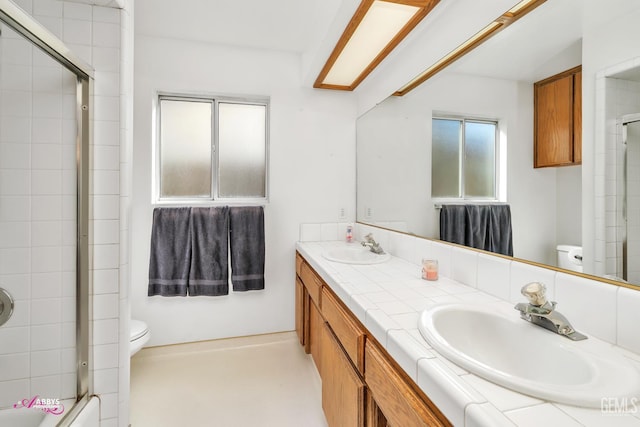 9812 Marilee Ave, Bakersfield, CA 93312 - full bathroom with toilet, double vanity, and shower / bath combination with glass door