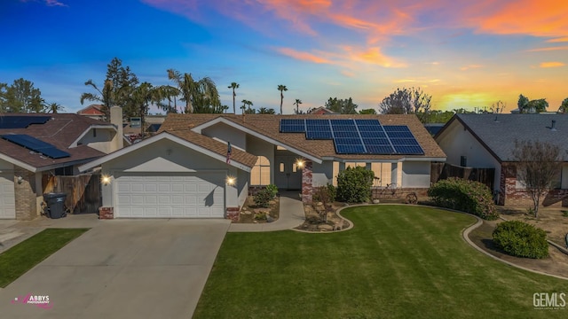 9812 Marilee Ave, Bakersfield, CA 93312 - ranch-style home featuring a garage, solar panels, a front yard, driveway, and a shingled roof
