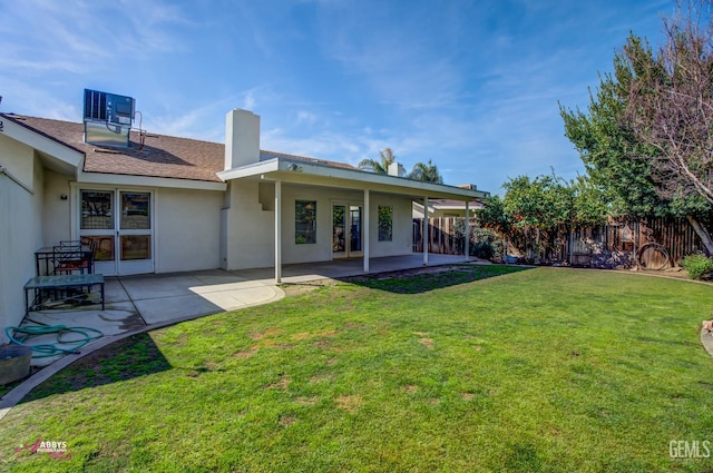 9812 Marilee Ave, Bakersfield, CA 93312 - back of property featuring a patio area, stucco siding, cooling unit, and a chimney