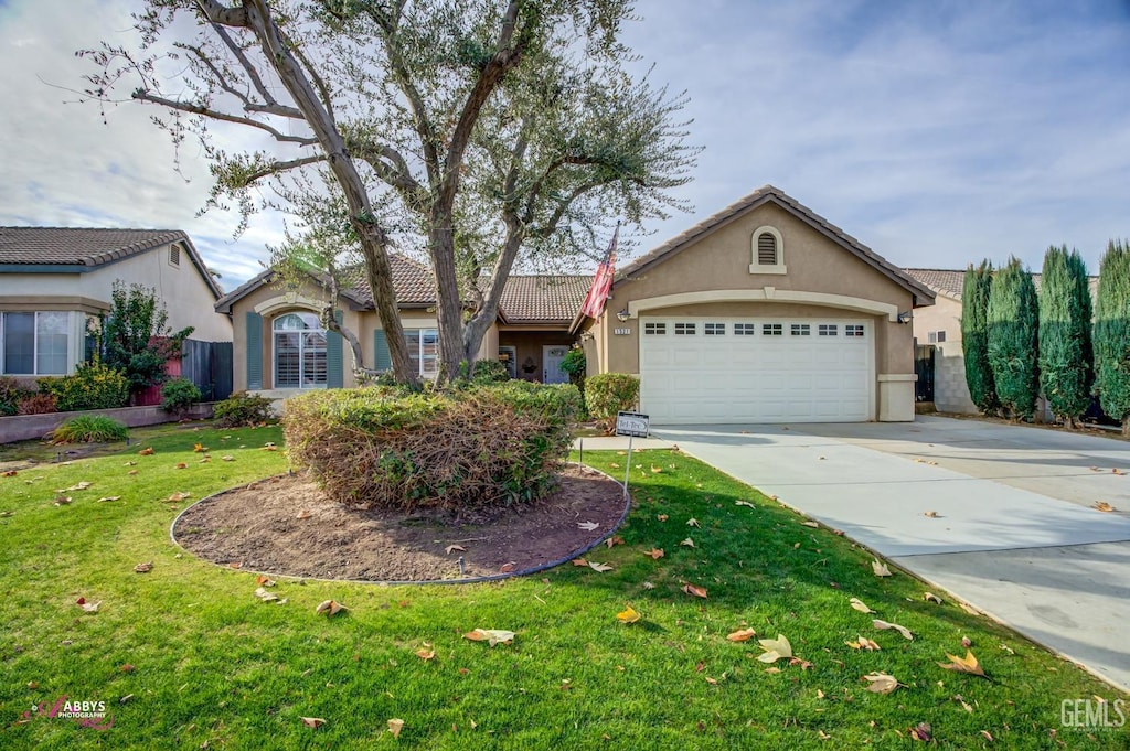 ranch-style home with a garage and a front yard