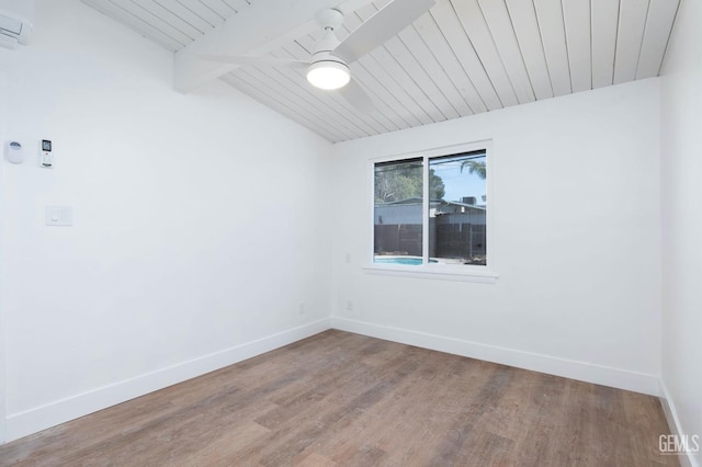 empty room featuring lofted ceiling with beams, wood finished floors, wood ceiling, a ceiling fan, and baseboards