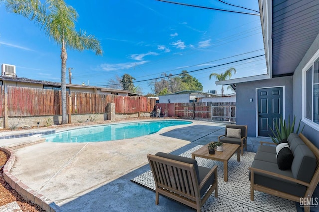 view of swimming pool featuring outdoor lounge area, a patio area, a fenced backyard, and a fenced in pool