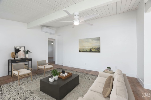 living room featuring baseboards, wood finished floors, beam ceiling, and a wall mounted air conditioner