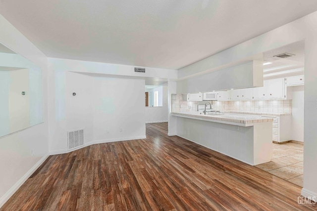 5500 Lennox Ave Unit 20, Bakersfield, CA 93309 - unfurnished living room featuring a sink and wood finished floors