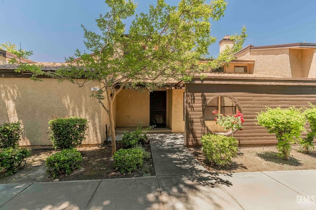 5500 Lennox Ave Unit 20, Bakersfield, CA 93309 - view of exterior entry featuring stucco siding and a chimney