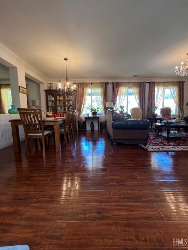 dining room with dark hardwood / wood-style floors, ornamental molding, and a chandelier