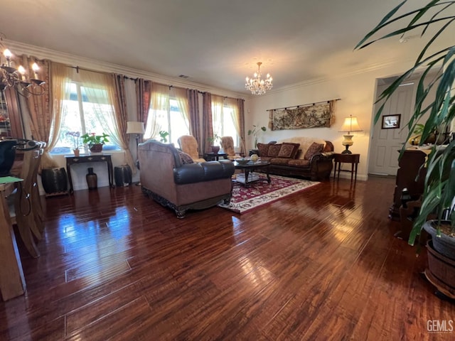 living room with dark hardwood / wood-style flooring, a chandelier, and ornamental molding