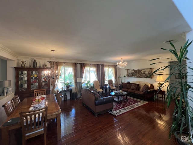 living room with dark hardwood / wood-style flooring, ornamental molding, and a notable chandelier