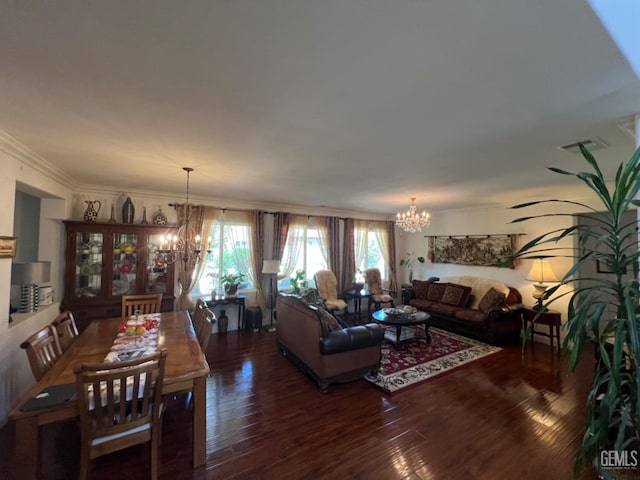 living room featuring dark hardwood / wood-style flooring, a chandelier, and ornamental molding