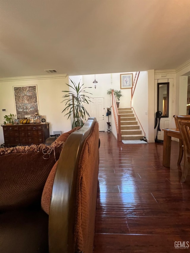 living room featuring dark hardwood / wood-style flooring and ornamental molding