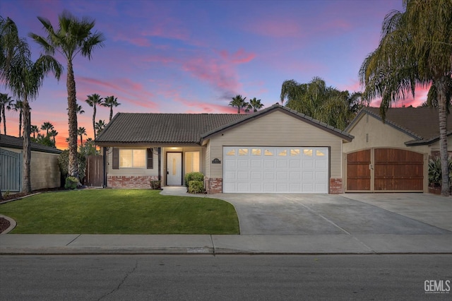 ranch-style home with a yard and a garage