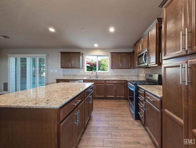 9029 Midnight Creek Way, Bakersfield, CA 93311 - kitchen featuring appliances with stainless steel finishes, plenty of natural light, recessed lighting, a kitchen island, and light stone counters