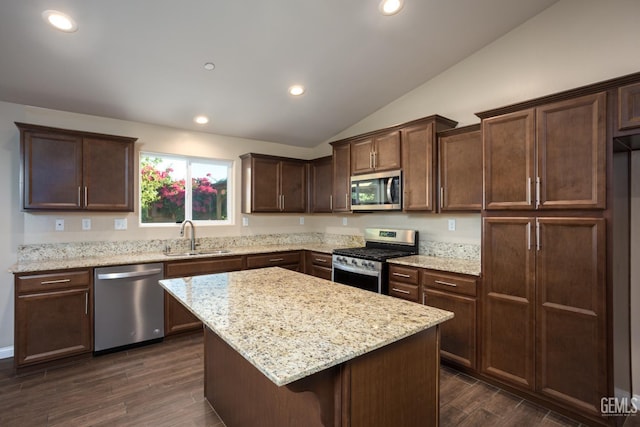9029 Midnight Creek Way, Bakersfield, CA 93311 - kitchen featuring appliances with stainless steel finishes, vaulted ceiling, dark brown cabinets, a center island, and dark wood-style flooring