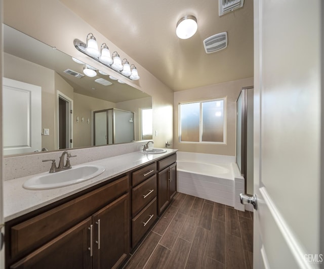 9029 Midnight Creek Way, Bakersfield, CA 93311 - full bathroom with double vanity, a garden tub, and wood finished floors