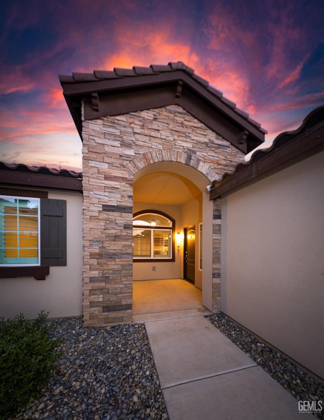 9029 Midnight Creek Way, Bakersfield, CA 93311 - entrance to property with stone siding, stucco siding, and a tile roof
