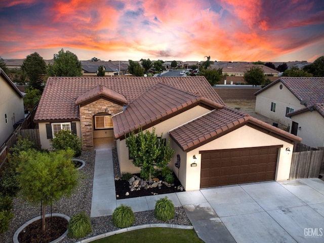 9029 Midnight Creek Way, Bakersfield, CA 93311 - view of front of home with stucco siding, a tile roof, concrete driveway, a garage, and stone siding