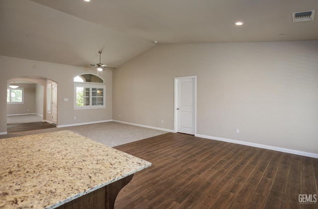9029 Midnight Creek Way, Bakersfield, CA 93311 - unfurnished living room featuring arched walkways, a ceiling fan, vaulted ceiling, dark wood-style flooring, and recessed lighting