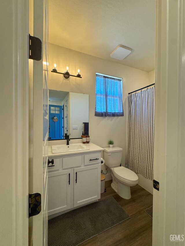 6722 Glacier Bay St, Bakersfield, CA 93313 - full bathroom with wood finished floors, vanity, and a shower with shower curtain