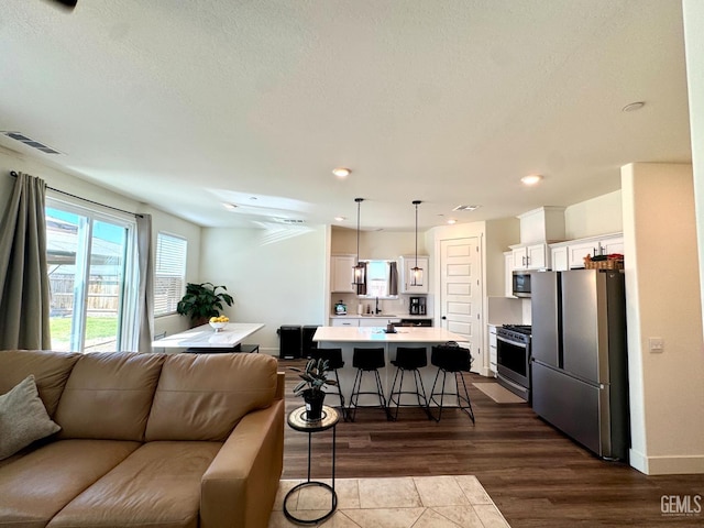 6722 Glacier Bay St, Bakersfield, CA 93313 - living area with dark wood-style flooring and recessed lighting