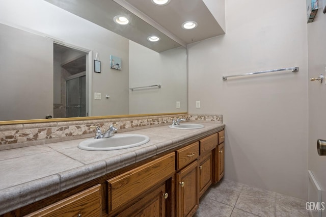 bathroom featuring tile patterned flooring and vanity