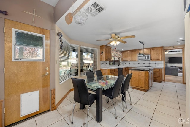 dining area with ceiling fan and light tile patterned floors