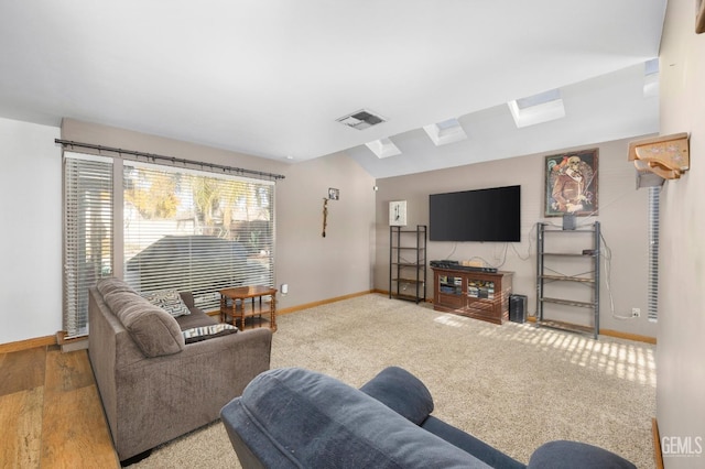 carpeted living room featuring vaulted ceiling