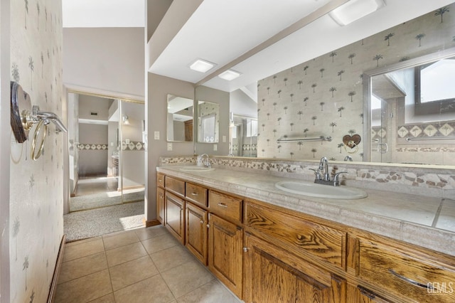 bathroom with backsplash, tile patterned flooring, and vanity