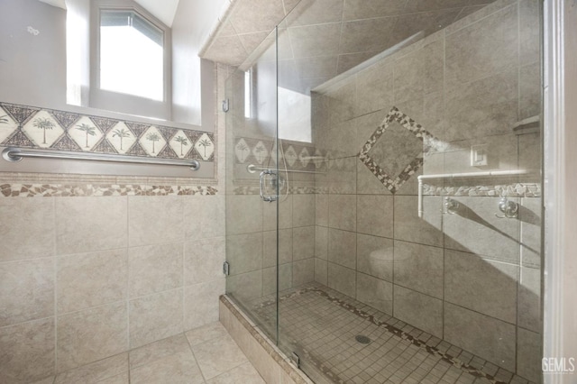 bathroom featuring tile patterned flooring and a shower with shower door