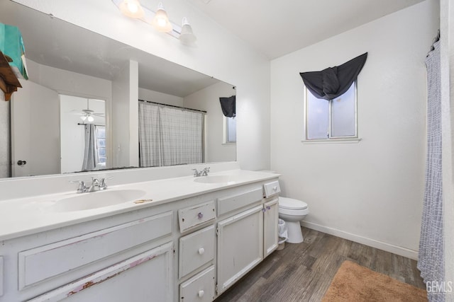 bathroom featuring vanity, hardwood / wood-style floors, and toilet