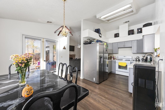 kitchen featuring gray cabinets, white stove, stainless steel refrigerator with ice dispenser, dark hardwood / wood-style flooring, and decorative light fixtures